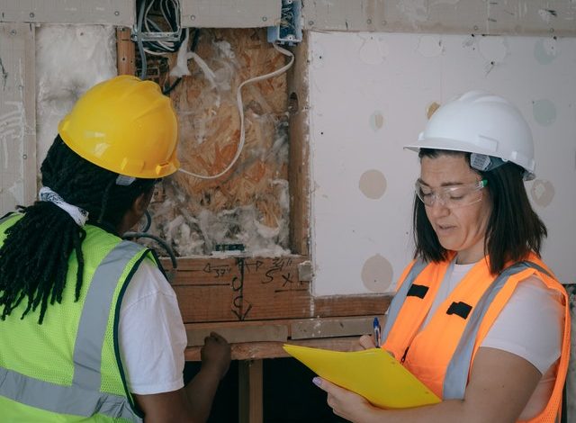 Two women inspecting a home